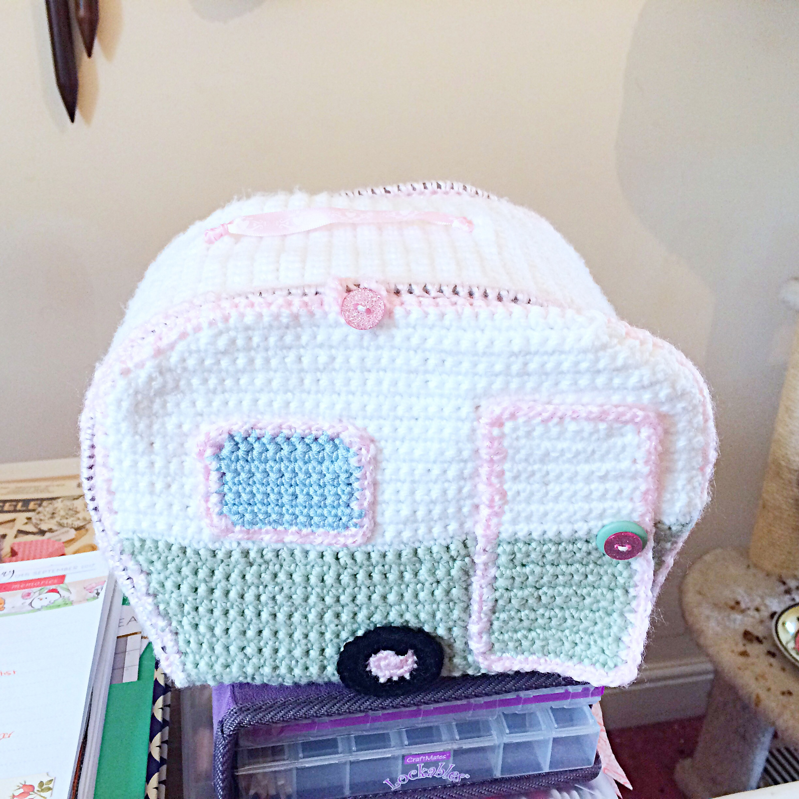 The exterior of a doll house style crocheted caravan